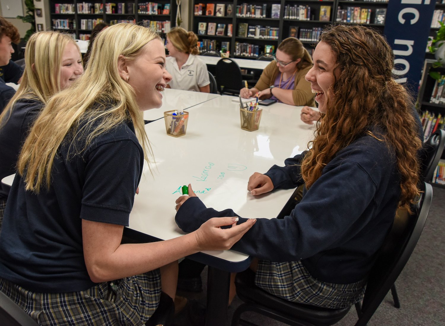 When asked what one of her favorite new foods in America is, Adriano Lozano, right, replied “Pop Tarts,” which drew laughter from her new friends at the table. Lozano has really become a fan of the sweet breakfast pastry. Lozano was staying with host sisters Kearra, middle left, and Cora Steinlage, at left, while attending Helias Catholic High School for seven days.